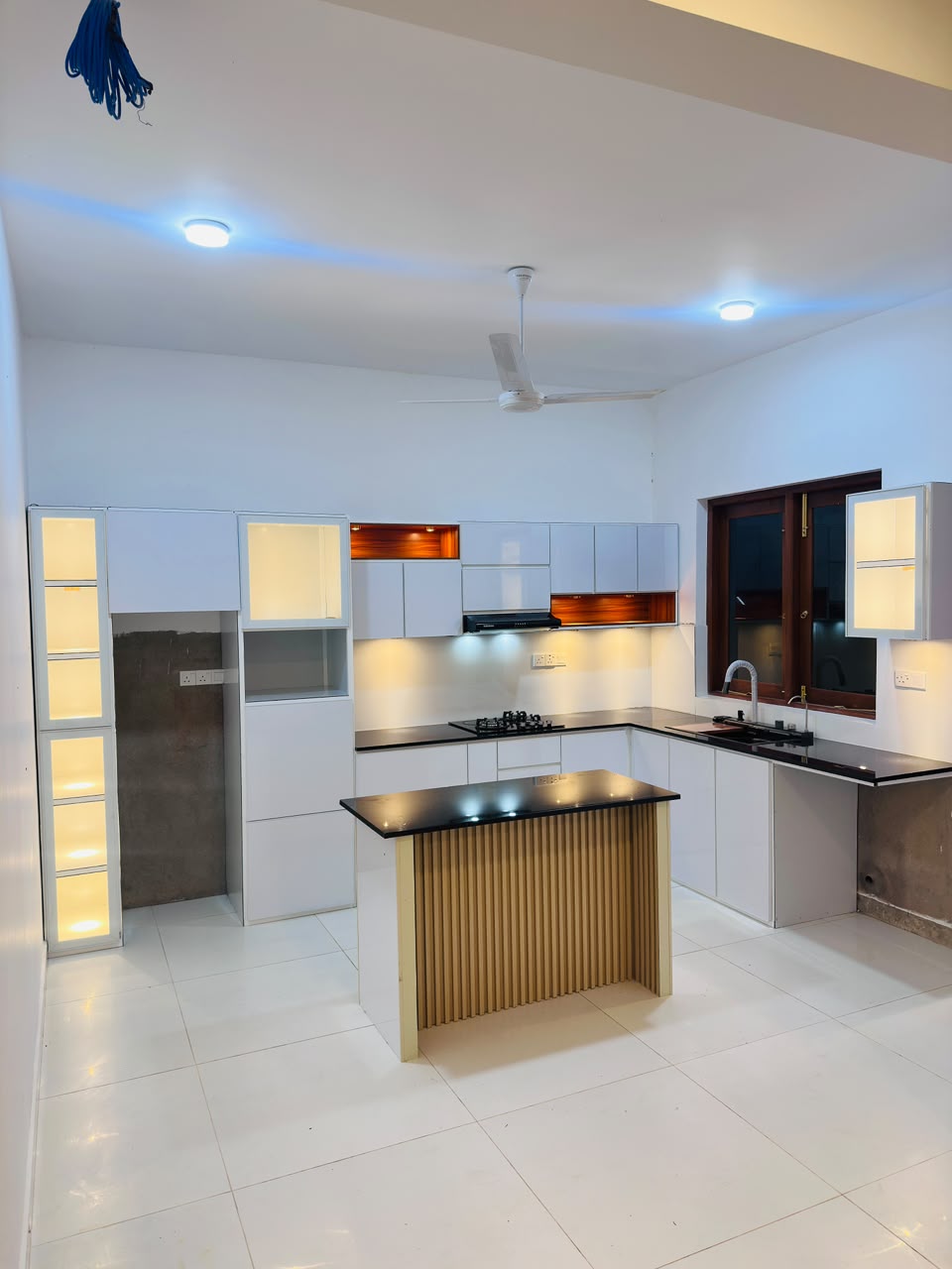 Black gloss kitchen with orange lit displays